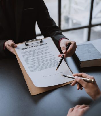 Businessmen and lawyers discuss and read the details of the treaty documents before signing the contract invest in business.