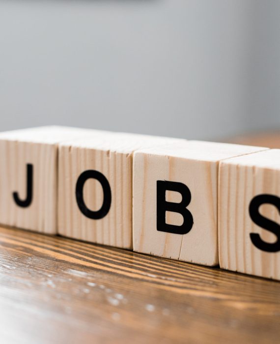 close-up shot of wooden cubes with JOBS sign on table